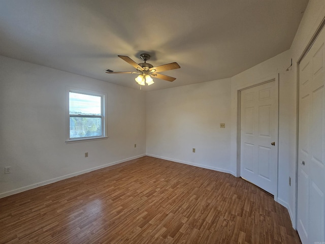 unfurnished bedroom with hardwood / wood-style floors and ceiling fan