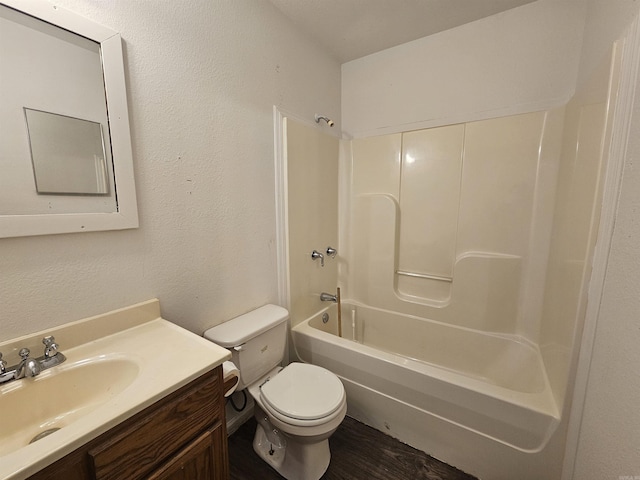 full bathroom featuring bathing tub / shower combination, vanity, and toilet