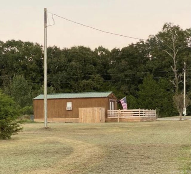 view of outdoor structure featuring a lawn