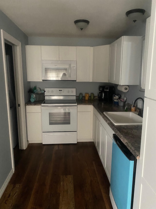 kitchen with dark hardwood / wood-style flooring, sink, white cabinets, and white appliances