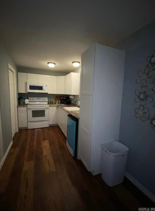 kitchen with sink, white appliances, dark hardwood / wood-style floors, and white cabinets