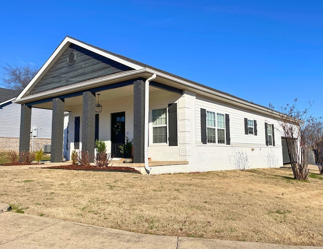 view of front of property with covered porch and a front lawn