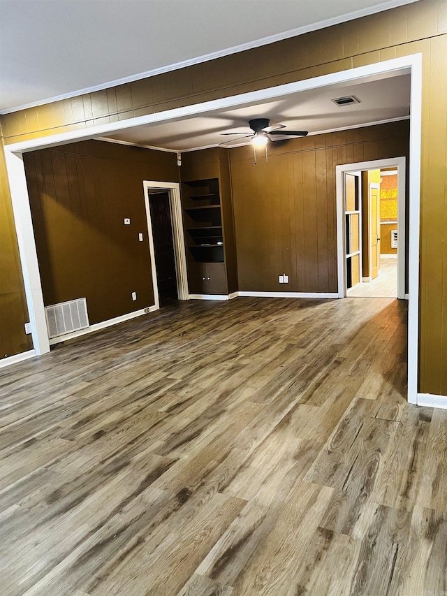 unfurnished room with hardwood / wood-style floors and ceiling fan