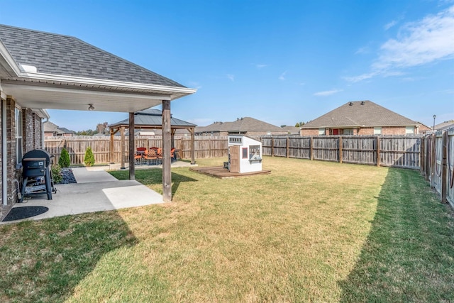 view of yard with a shed, a patio area, and a gazebo