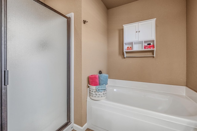 bathroom with shower with separate bathtub