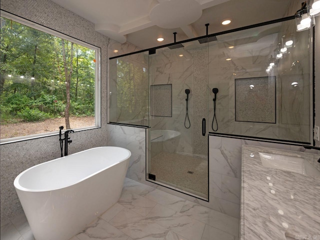 bathroom with shower with separate bathtub and tile walls