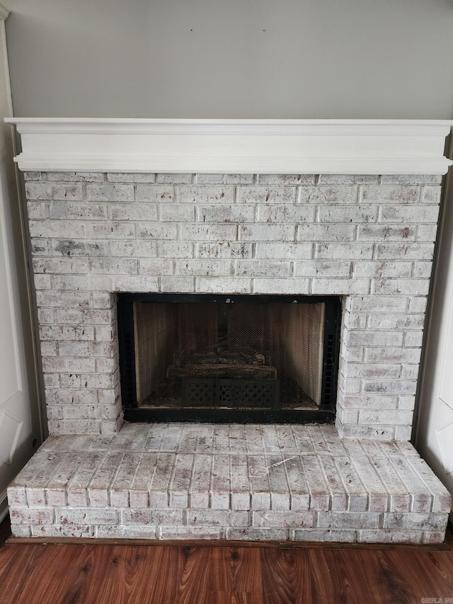 interior details with a brick fireplace