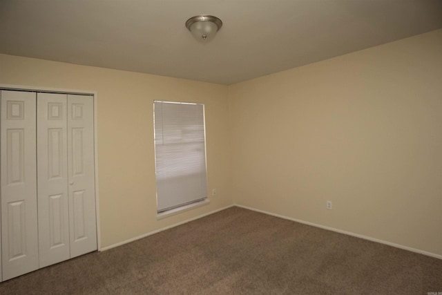 unfurnished bedroom with carpet floors and a closet