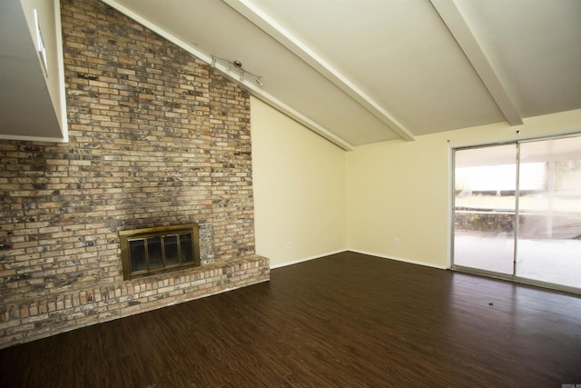 unfurnished living room featuring a brick fireplace, lofted ceiling with beams, and wood-type flooring