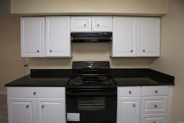 kitchen with electric range and white cabinetry