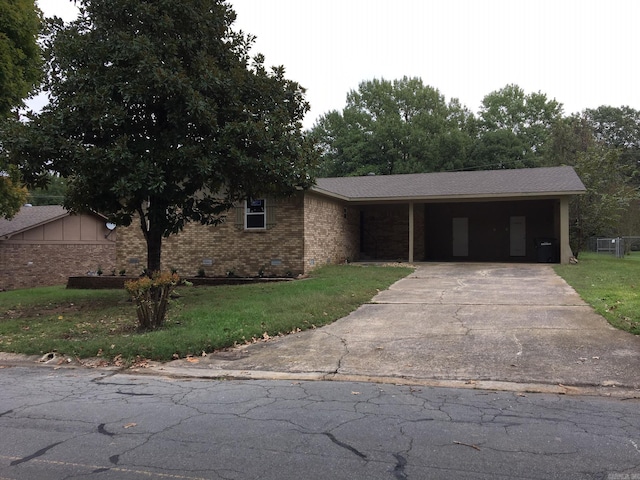 ranch-style house with a carport and a front lawn