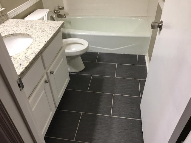 bathroom featuring tile patterned floors, vanity, and toilet