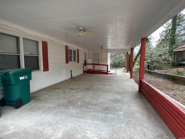 view of patio with a carport and a ceiling fan