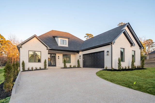 view of front of property with a front yard and a garage