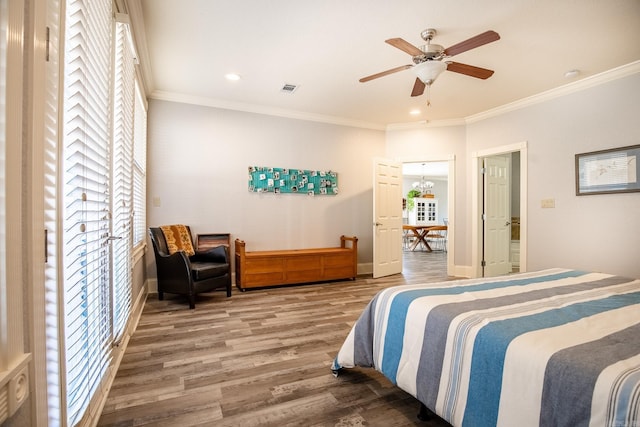 bedroom featuring ceiling fan, crown molding, and wood-type flooring