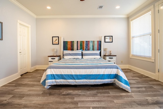 bedroom with ornamental molding and dark hardwood / wood-style flooring