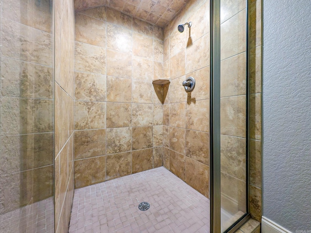 bathroom with a tile shower