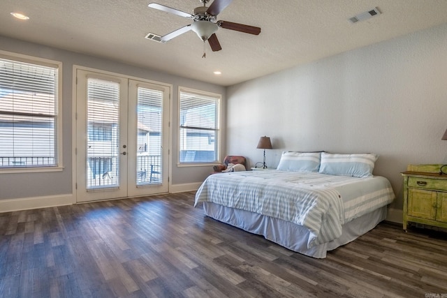 bedroom with french doors, multiple windows, ceiling fan, and dark hardwood / wood-style flooring