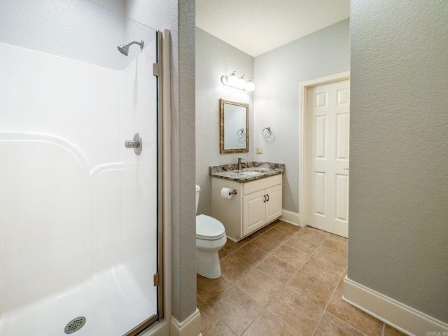 bathroom with toilet, a shower, and vanity