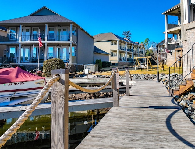 dock area with a playground and a water view