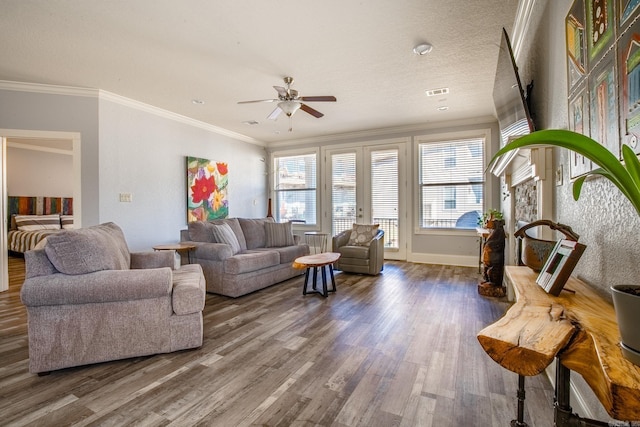 living room with ceiling fan, crown molding, dark hardwood / wood-style floors, and a textured ceiling