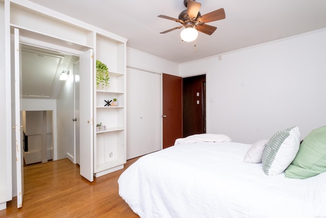 bedroom with ceiling fan, light hardwood / wood-style floors, and crown molding