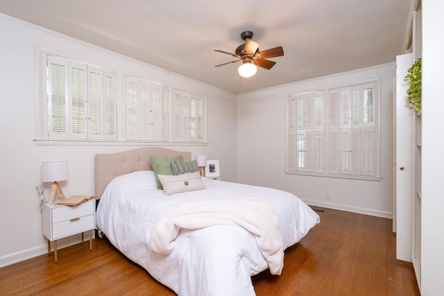 bedroom with hardwood / wood-style flooring, ceiling fan, and crown molding