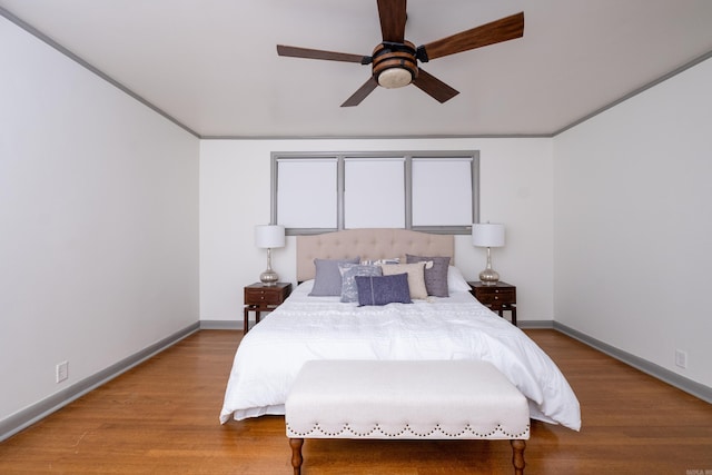 bedroom with ceiling fan, light wood-type flooring, and crown molding