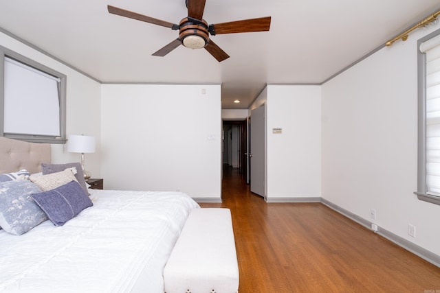 unfurnished bedroom with ceiling fan, crown molding, and hardwood / wood-style floors