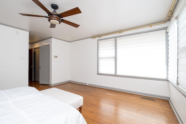 unfurnished bedroom featuring ceiling fan and hardwood / wood-style flooring