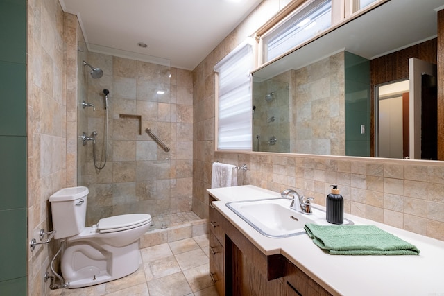 bathroom with toilet, vanity, tile walls, a tile shower, and tasteful backsplash