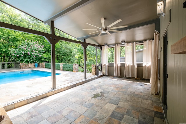 view of pool with ceiling fan and a patio area