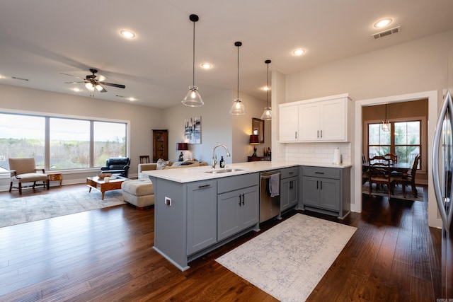 kitchen with sink, dishwasher, ceiling fan, backsplash, and gray cabinets