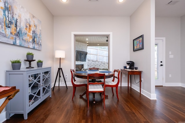 dining space with dark wood-type flooring