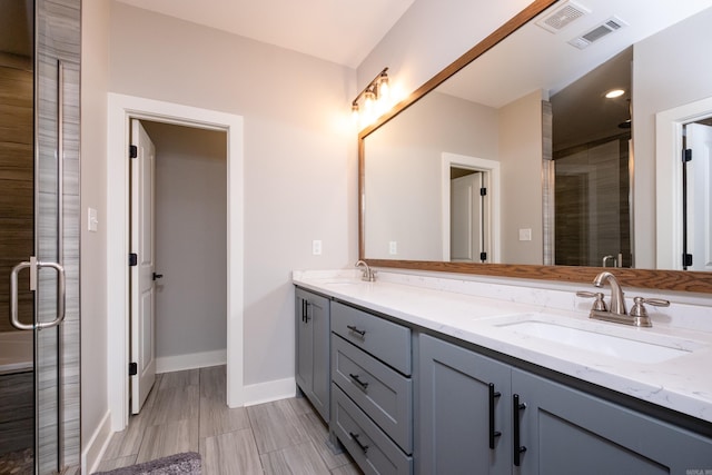 bathroom featuring walk in shower and vanity