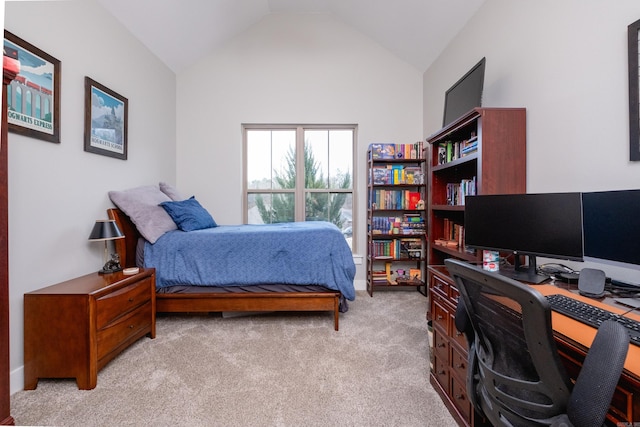 bedroom with vaulted ceiling and light carpet