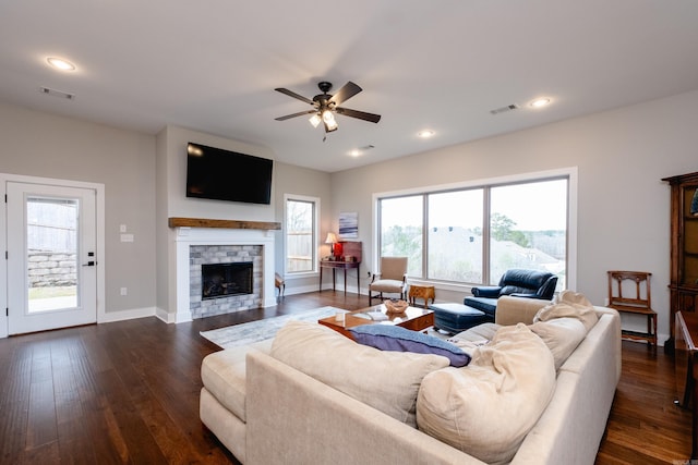 living room featuring a fireplace, ceiling fan, and dark hardwood / wood-style flooring