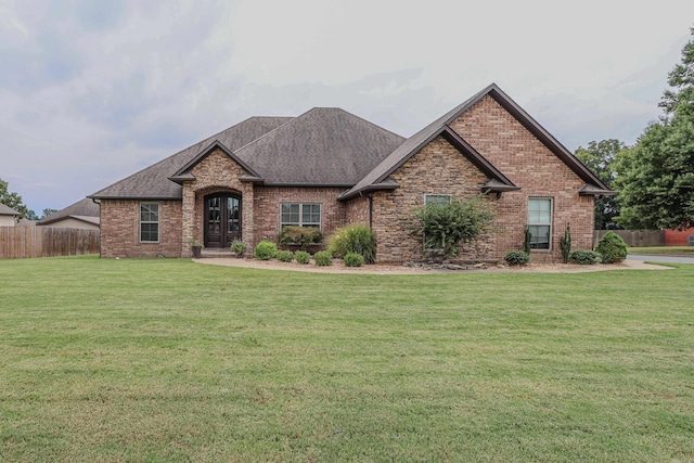 view of front facade featuring french doors and a front lawn