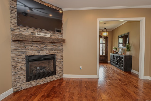 unfurnished living room featuring a fireplace, ornamental molding, and wood-type flooring