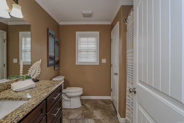 bathroom with toilet, vanity, and crown molding