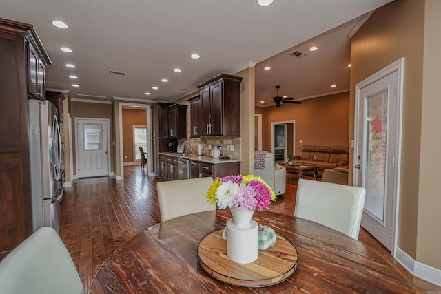 dining room with ceiling fan, crown molding, dark hardwood / wood-style flooring, and sink