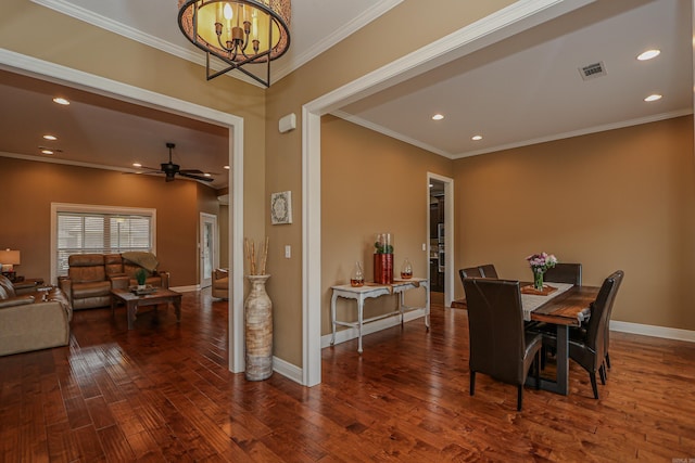 dining space with ceiling fan with notable chandelier, crown molding, and dark hardwood / wood-style flooring