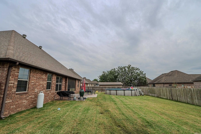 view of yard with a fenced in pool