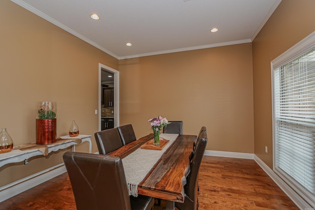 dining area featuring crown molding and hardwood / wood-style floors