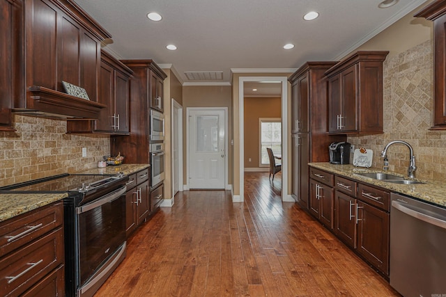 kitchen with light stone counters, stainless steel appliances, crown molding, and sink