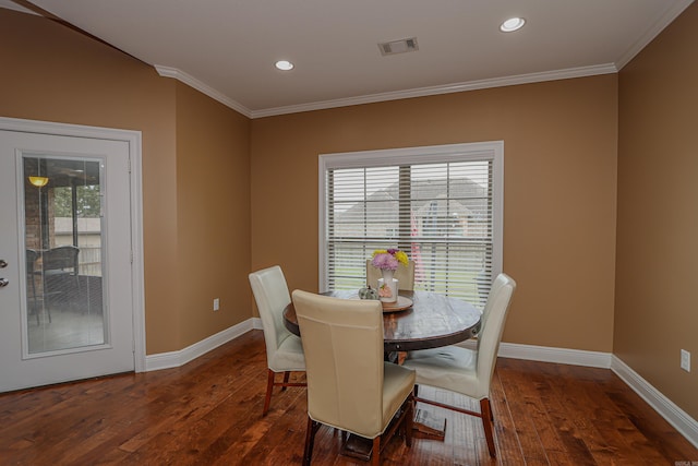 dining area featuring ornamental molding and dark hardwood / wood-style floors