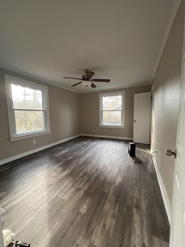 unfurnished room featuring ornamental molding, dark wood-type flooring, and ceiling fan