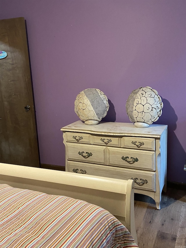 bedroom with dark hardwood / wood-style floors