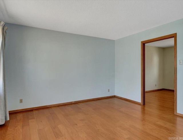 empty room with light hardwood / wood-style flooring