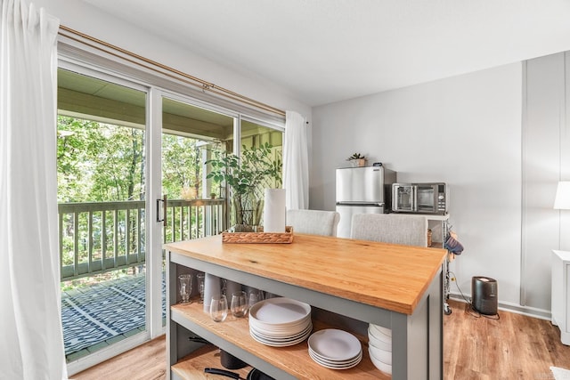 dining space with light wood-type flooring